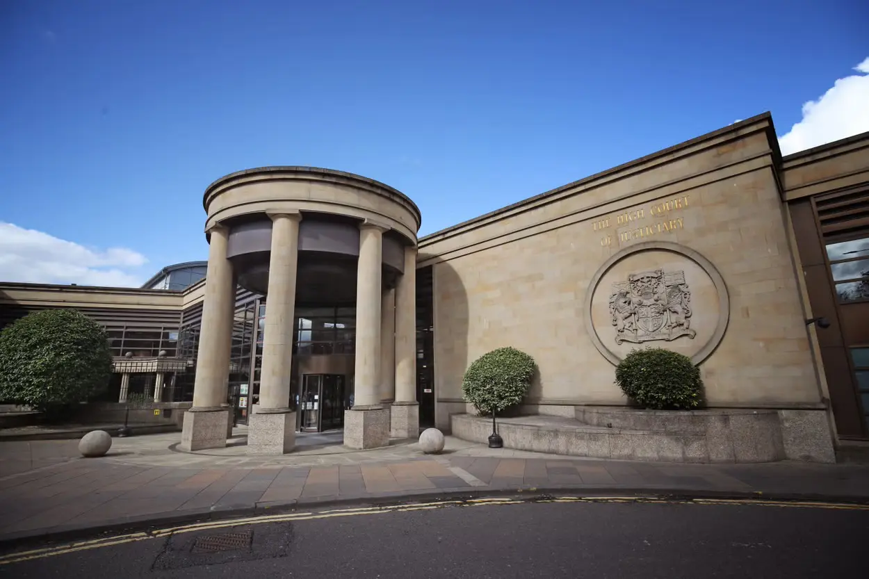 A building with pillars and a large circular window.