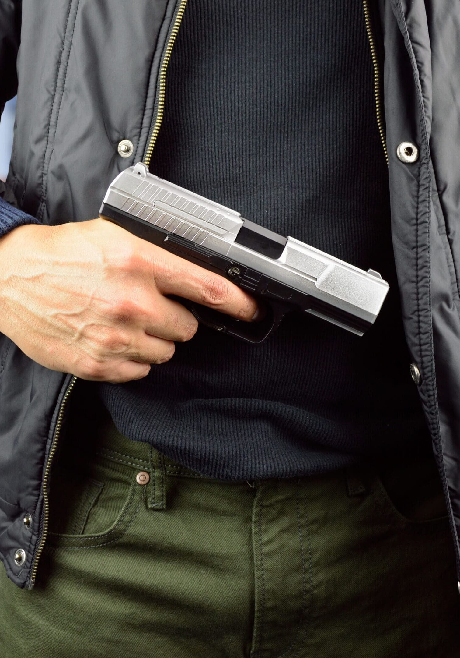 closeup of an armed terrorist with street background